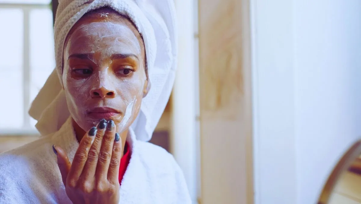 woman noticing darker facial skin compared to body
