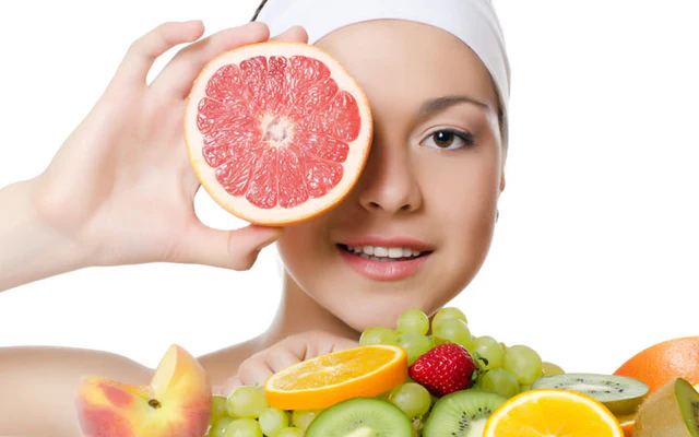 Woman eating healthy fruits for radiant and clear skin