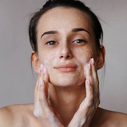 Woman following summer skincare routine to prevent open pores. Woman following summer skincare routine to prevent open pores.